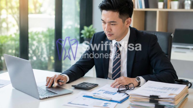 Professional Indonesian accountant analyzing financial graphs and tax reports on a laptop, providing Corporate Services and Tax Accounting Indonesia.